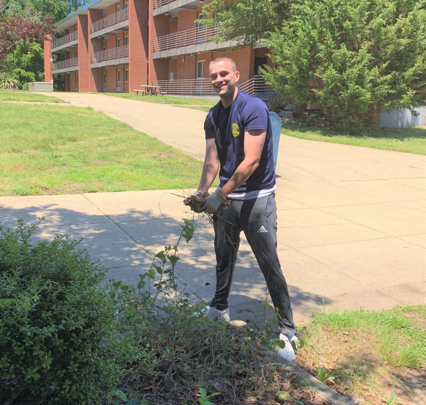 Sailor cleans up barracks grounds during time off
